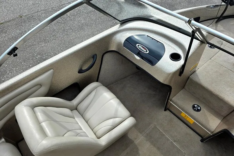 Slide: The Image of 2005 Triton SF18 F&S boat interior with beige seating and dashboard. - 7