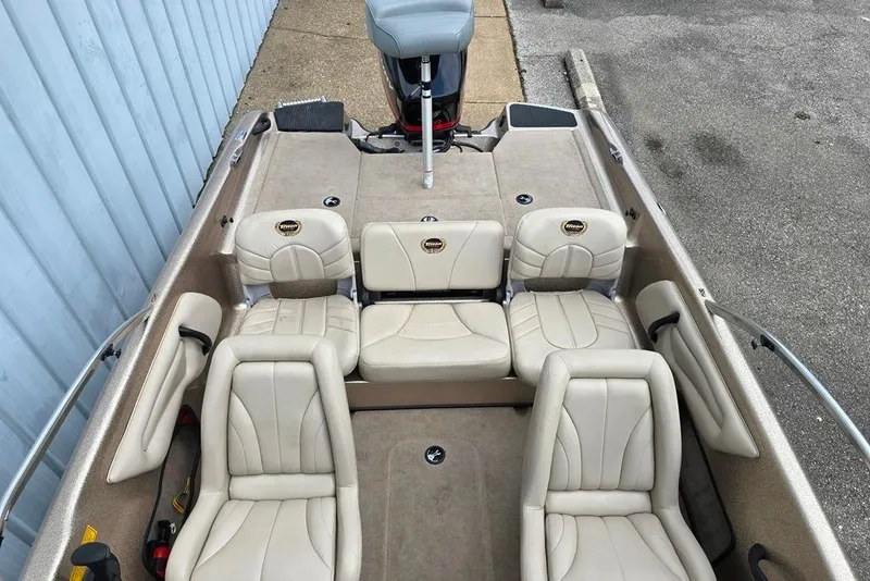 Slide: The Image of 2005 Triton SF18 F&S boat interior with beige seating and steering console. - 8