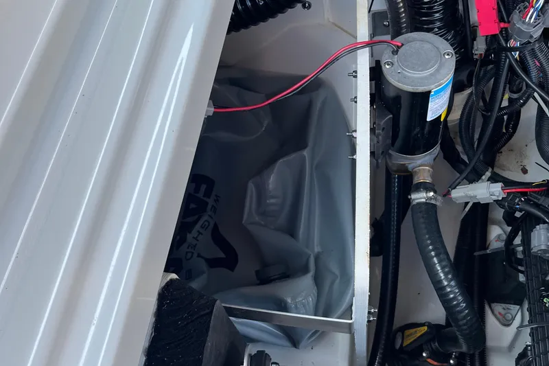 Slide: The Image of 2024 Yamaha Boats 255XD engine compartment with wiring and components visible. - 11