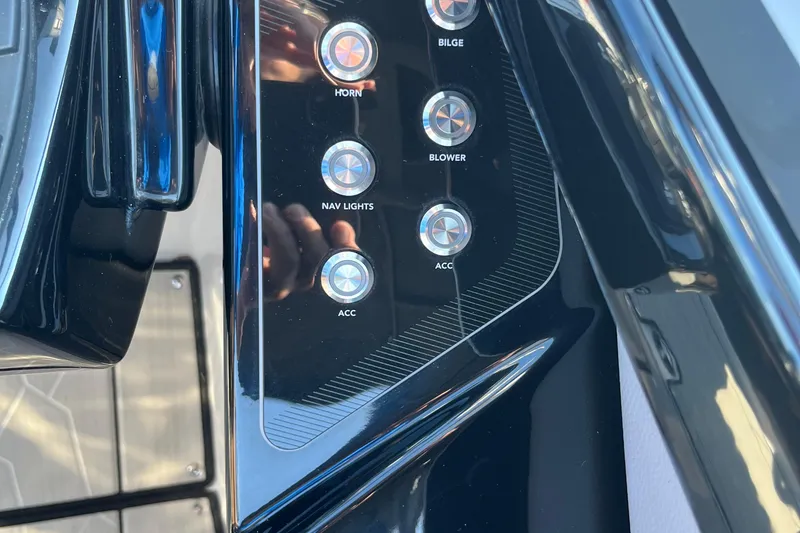 Slide: The Image of Control panel of 2024 Yamaha Boats 255XD with labeled buttons for various functions. - 13