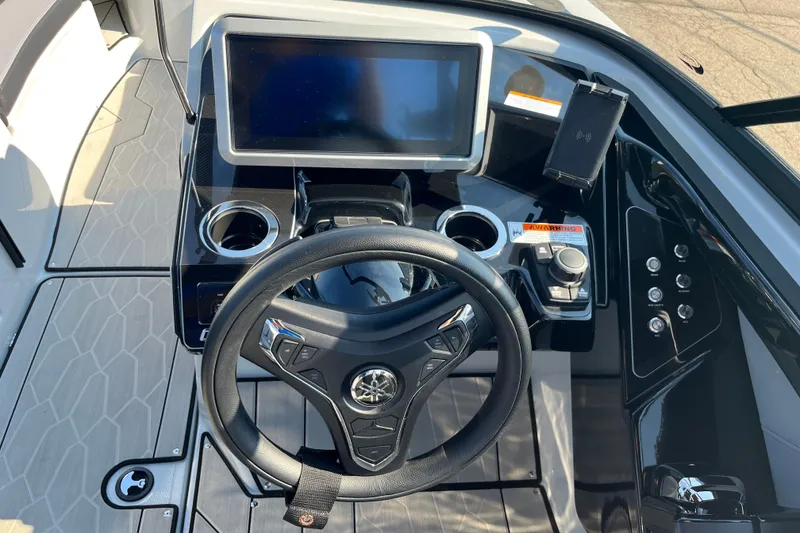Slide: The Image of 2024 Yamaha Boats 255XD dashboard with steering wheel and touchscreen display. - 14