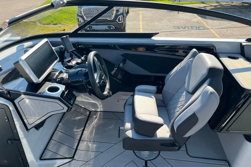 Slide: The Image of 2024 Yamaha Boats 255XD cockpit with modern controls and comfortable seating. - 16