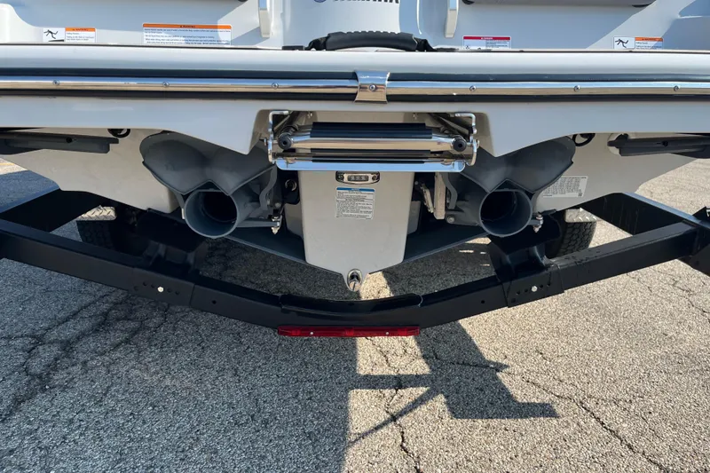 Slide: The Image of Rear view of 2024 Yamaha Boats 255XD, showcasing dual exhaust and trailer. - 17