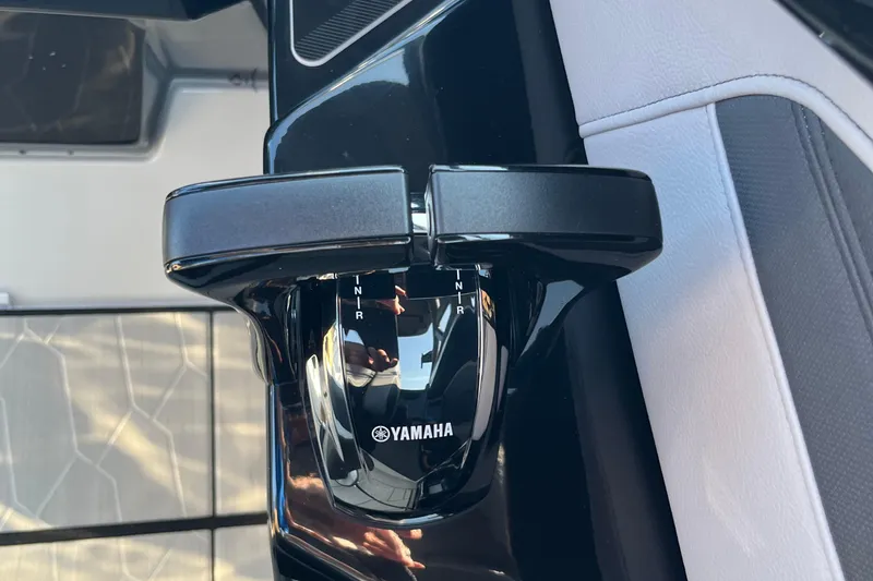 Slide: The Image of Close-up of 2024 Yamaha Boats 255XD throttle control in a sleek interior. - 21