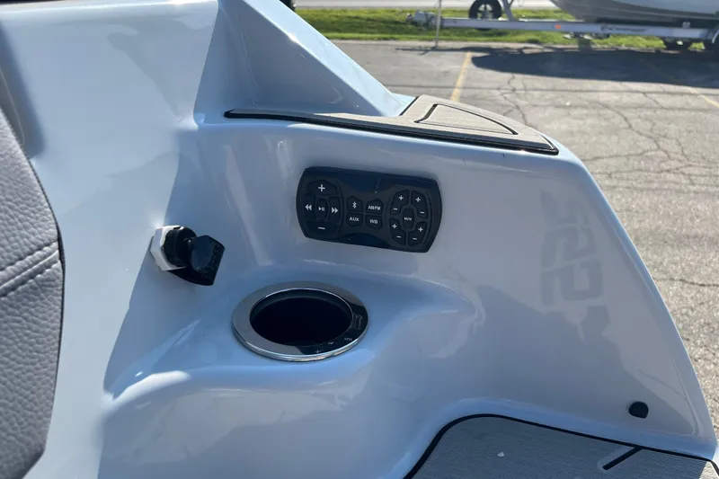 Slide: The Image of 2024 Yamaha Boats 255XD control panel with cup holder and audio controls. - 25