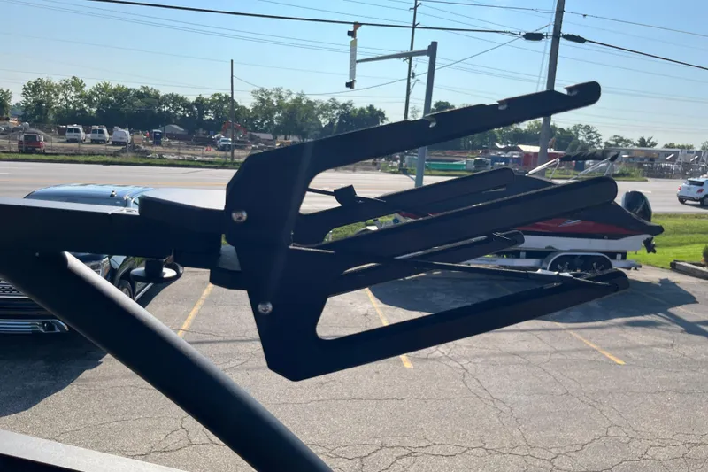 Slide: The Image of 2024 Yamaha Boats 255XD wakeboard rack in a parking lot setting. - 26