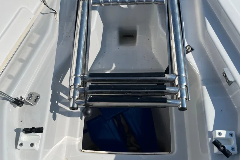 Slide: The Image of 2024 Yamaha Boats 255XD swim ladder and storage compartment detail. - 4