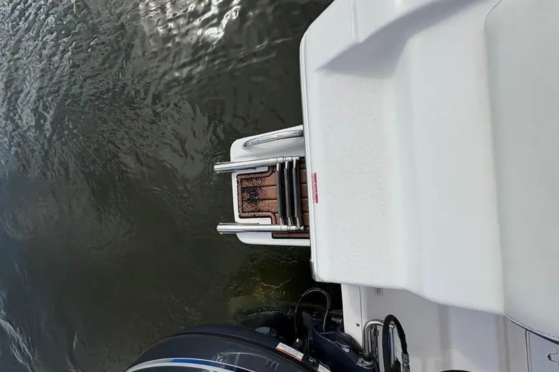 Slide: The Image of 2017 Tidewater 180 CC Adventure boat with swim platform and ladder on water. - 13