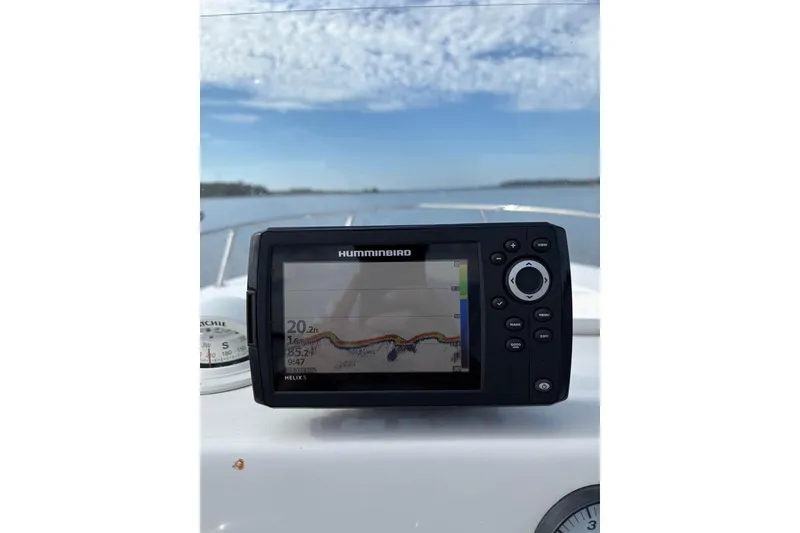 Slide: The Image of Humminbird fish finder on 2017 Tidewater 180 CC Adventure boat, clear sky, calm water. - 19