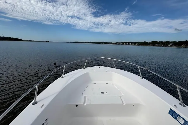 Slide: The Image of 2017 Tidewater 180 CC Adventure boat on calm water under a partly cloudy sky. - 6