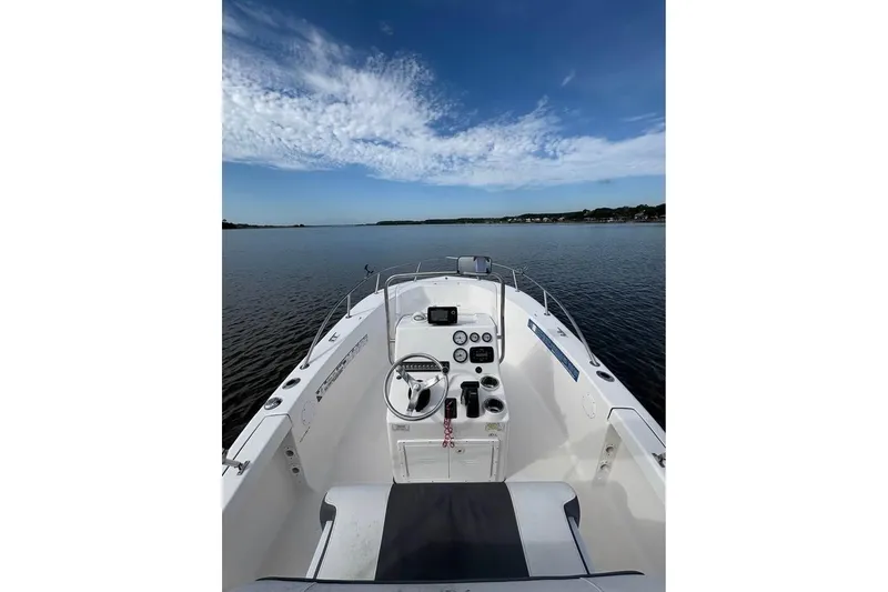 Slide: The Image of 2017 Tidewater 180 CC Adventure boat on calm water under a blue sky. - 9