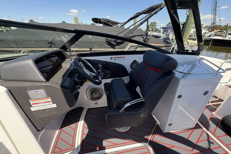 Slide: The Image of Interior of 2026 Monterey M65 boat, featuring sleek helm and luxurious seating. - 11