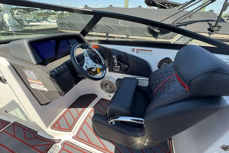 Slide: The Image of 2026 Monterey M65 boat cockpit with modern steering, digital display, and luxurious seating. - 12