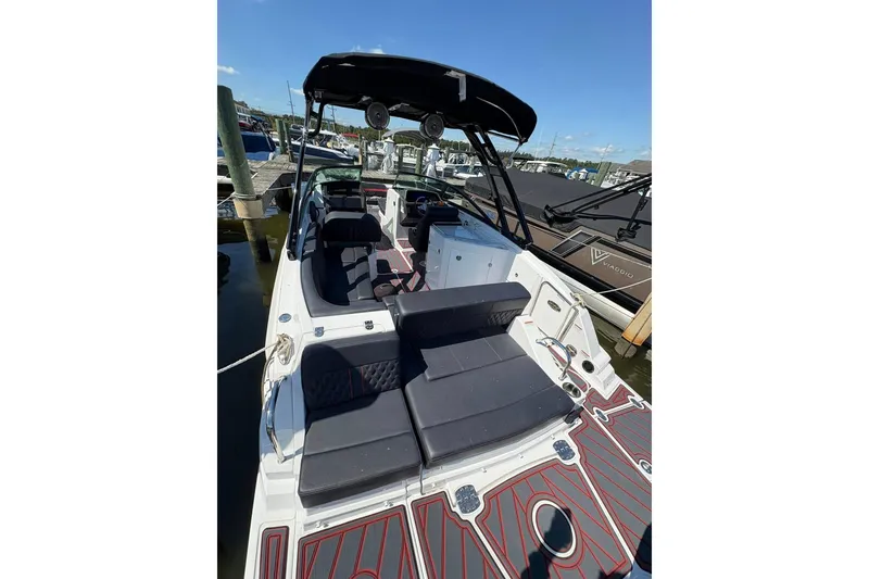 Slide: The Image of 2026 Monterey M65 boat with sleek seating and modern design at a marina. - 15