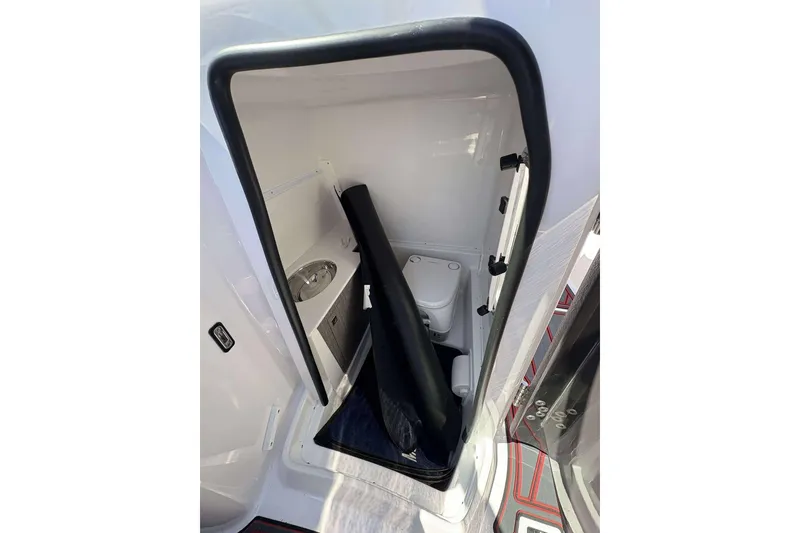 Slide: The Image of Compact bathroom in 2026 Monterey M65 boat, featuring a toilet and sink. - 16