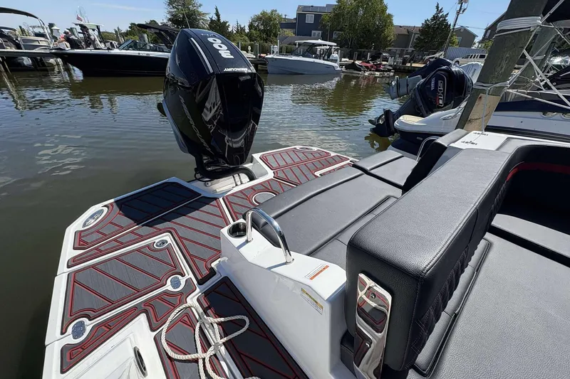 Slide: The Image of Monterey M65 2026 boat with sleek design and powerful outboard motor at marina. - 19