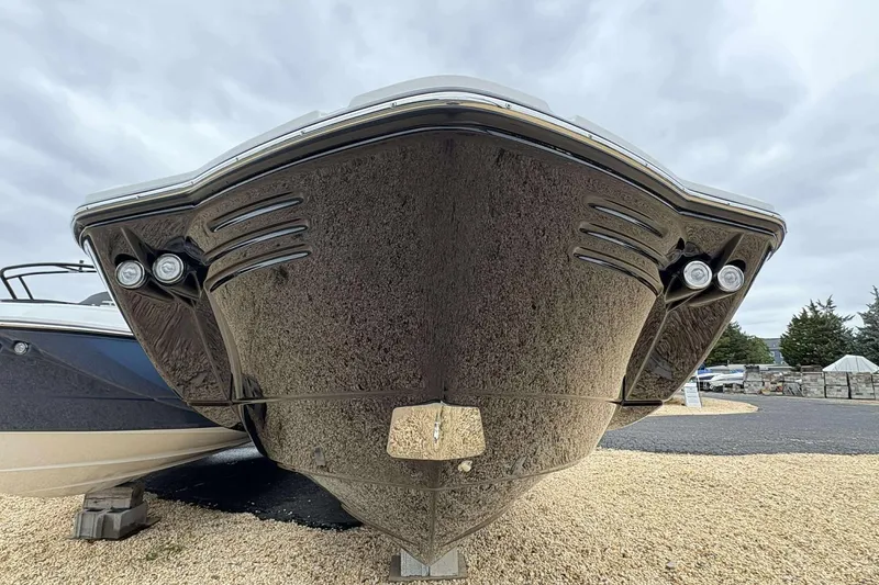 Slide: The Image of Front view of a 2026 Monterey M65 boat on display, showcasing sleek design and lighting. - 4