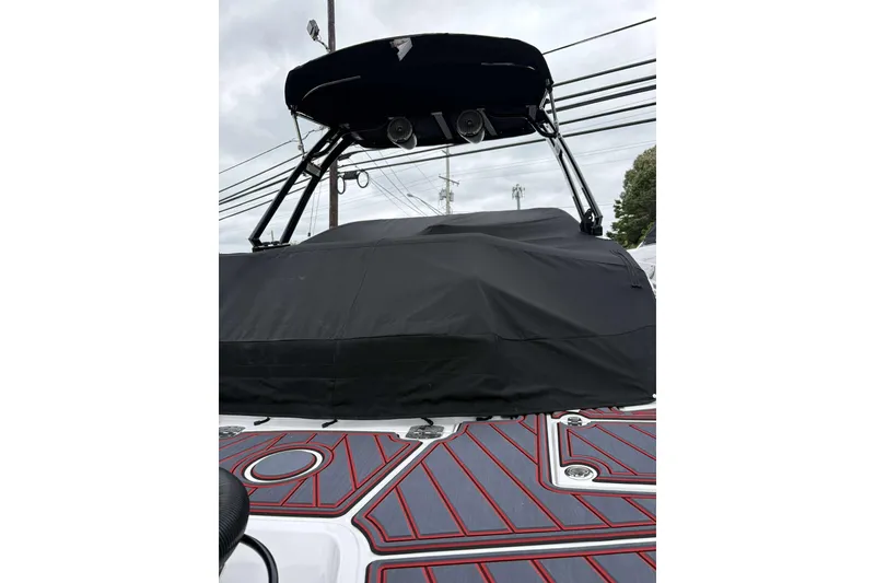 Slide: The Image of 2026 Monterey M65 boat with black cover and stylish deck design. - 7