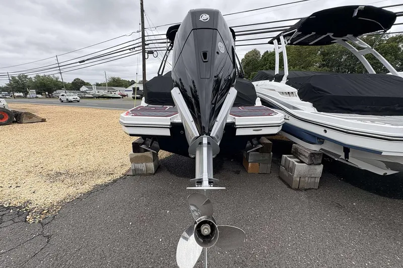 Slide: The Image of 2026 Monterey M65 boat with outboard motor on display, parked on blocks. - 9