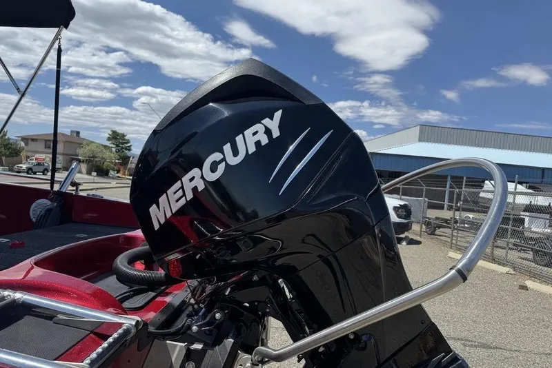 Slide: The Image of Mercury outboard motor on 2017 Nitro ZV18 boat, parked outdoors under blue sky. - 12