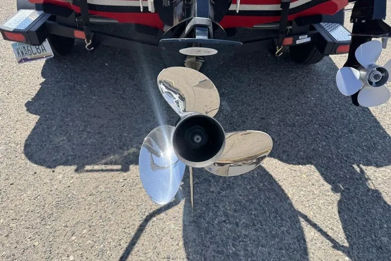 Slide: The Image of 2017 Nitro ZV18 boat propeller on trailer, shiny metal blades, outdoor setting. - 14