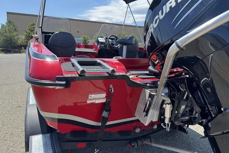 Slide: The Image of Red 2017 Nitro ZV18 boat with Mercury engine, parked on a trailer. - 15