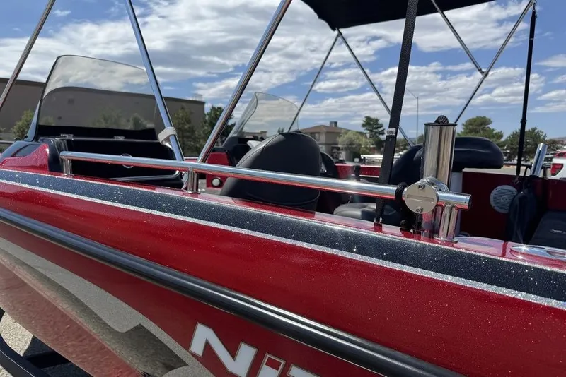 Slide: The Image of 2017 Nitro ZV18 boat with red exterior and chrome details under a blue sky. - 18