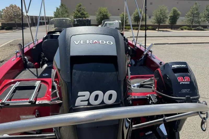 Slide: The Image of 2017 Nitro ZV18 boat with Verado 200 and Mercury 9.9 engines, parked outdoors. - 20