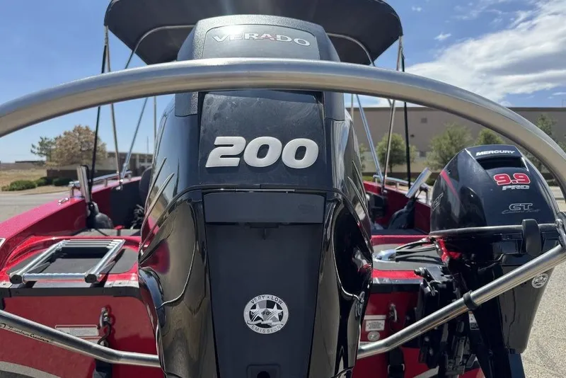 Slide: The Image of 2017 Nitro ZV18 boat with Mercury Verado 200 and 9.9 engines, parked outdoors. - 22