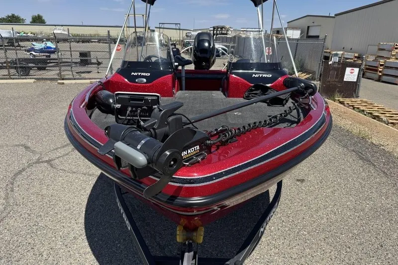 Slide: The Image of 2017 Nitro ZV18 boat with trolling motor, parked outdoors on a sunny day. - 24