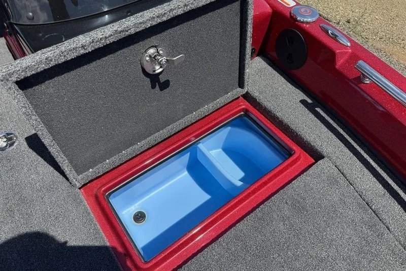 Slide: The Image of Open storage compartment on a 2017 Nitro ZV18 boat, featuring a blue interior. - 32