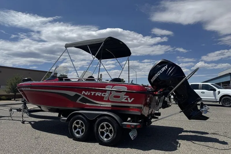 Slide: The Image of 2017 Nitro ZV18 boat with Mercury engine on trailer, under clear blue sky. - 4