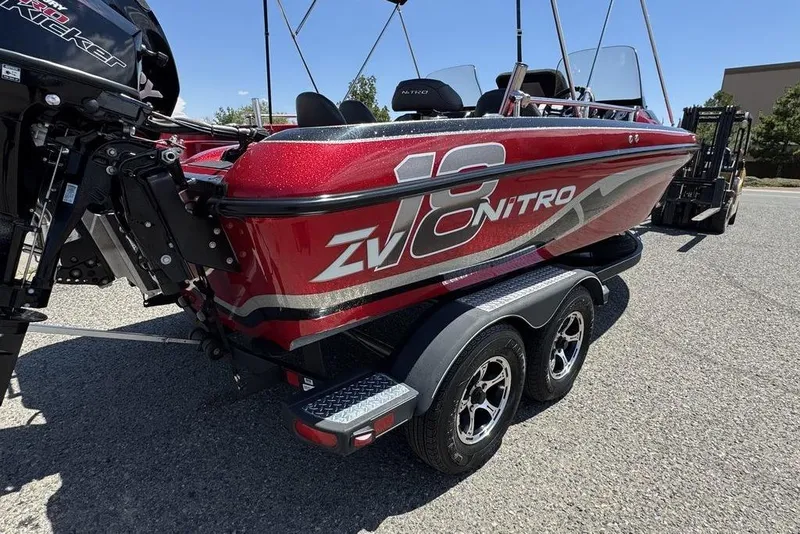 Slide: The Image of 2017 Nitro ZV18 boat on trailer, red exterior, parked outdoors. - 43