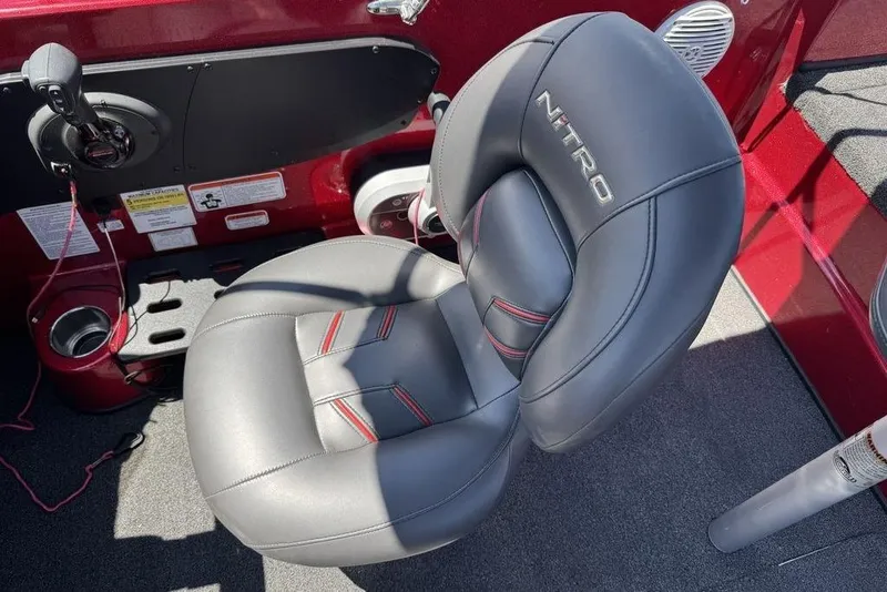 Slide: The Image of Gray leather seat in a 2017 Nitro ZV18 boat, featuring red accents and cup holder. - 47