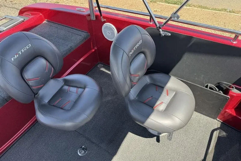 Slide: The Image of 2017 Nitro ZV18 boat interior with two gray seats and red accents. - 49