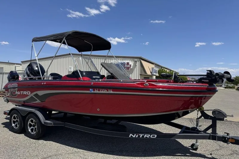 Slide: The Image of 2017 Nitro ZV18 boat in red, parked on a trailer under a clear blue sky. - 50