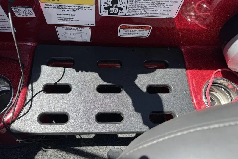 Slide: The Image of 2017 Nitro ZV18 boat dashboard with safety labels and cup holder. - 57