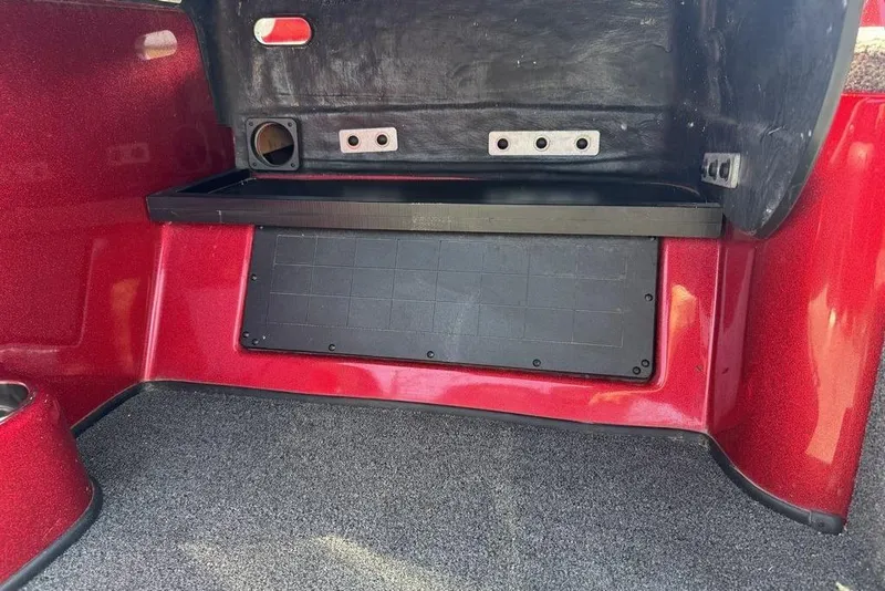 Slide: The Image of Red interior compartment of a 2017 Nitro ZV18 boat, featuring storage space. - 64