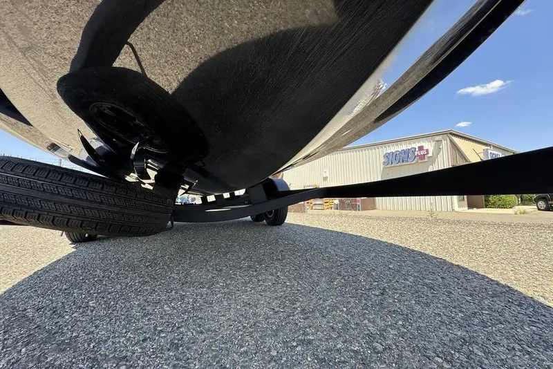 Slide: The Image of Underneath view of a 2017 Nitro ZV18 boat on a trailer, parked on gravel. - 65