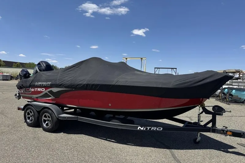 Slide: The Image of 2017 Nitro ZV18 boat with cover on trailer under clear blue sky. - 67