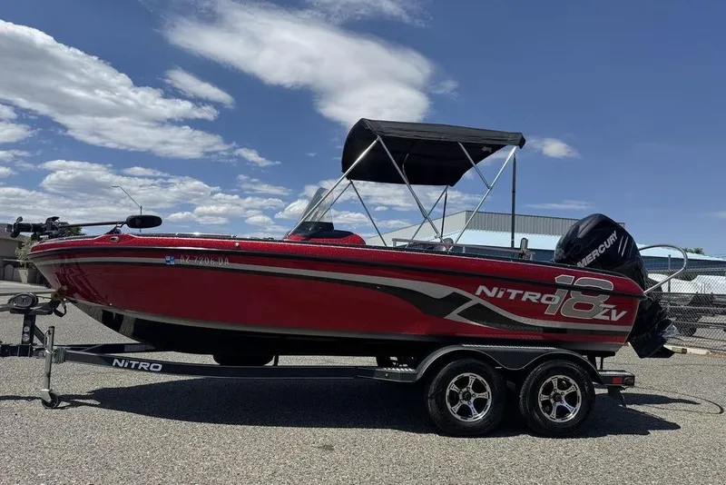 Slide: The Image of 2017 Nitro ZV18 boat with Mercury engine on trailer, under clear sky. - 7