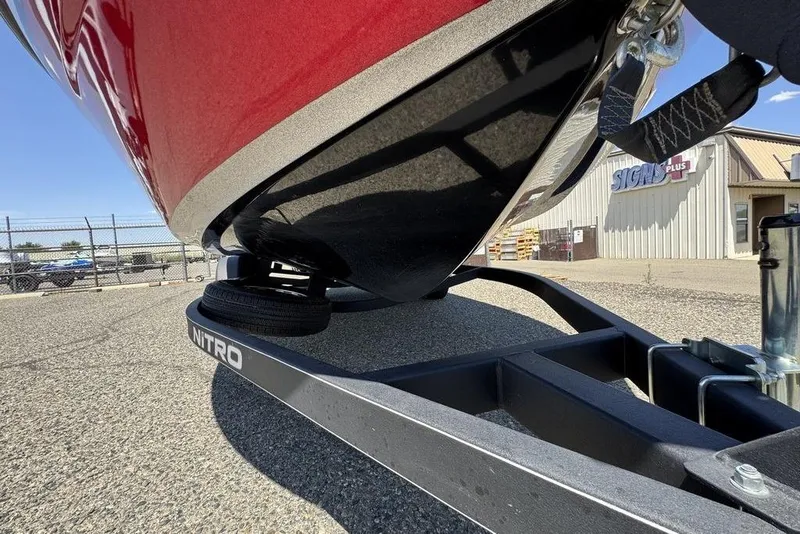 Slide: The Image of 2017 Nitro ZV18 boat on trailer, close-up view, red hull, outdoor setting. - 71