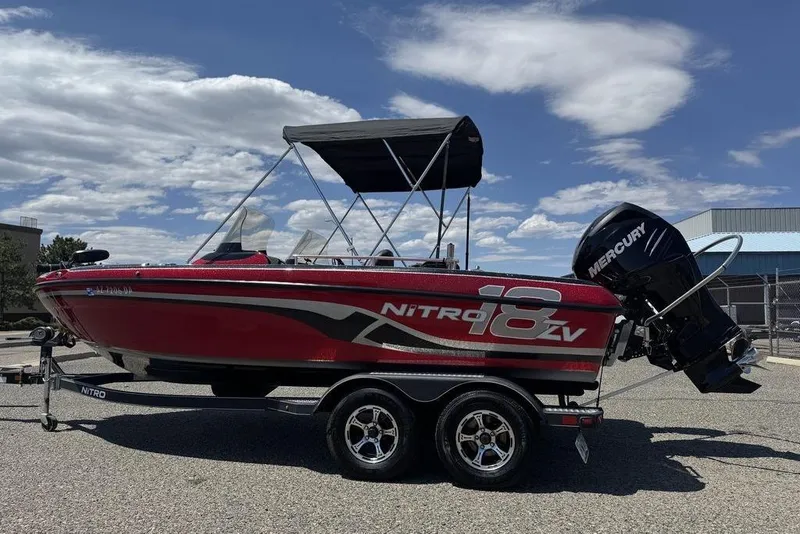 Slide: The Image of 2017 Nitro ZV18 boat with Mercury engine on trailer under blue sky. - 8