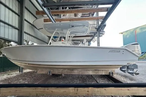 The Image of 2015 Jupiter 30 CC boat in storage, side view, under shelter. - 0