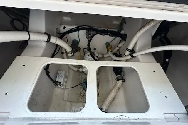 Slide: The Image of 2015 Jupiter 30 CC boat interior showing plumbing and wiring components. - 14