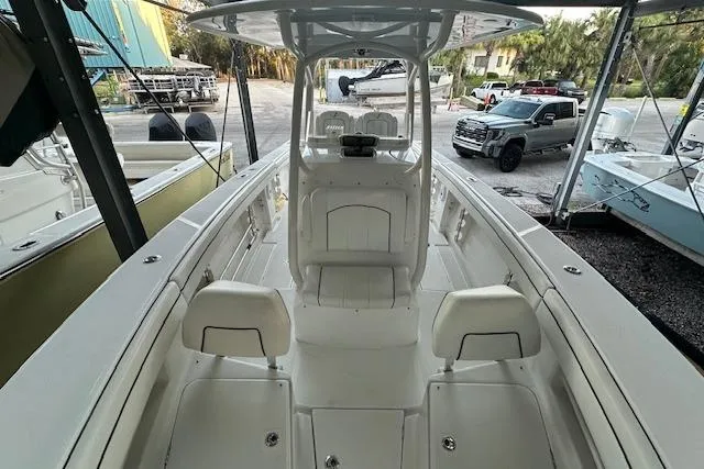 Slide: The Image of 2015 Jupiter 30 CC boat interior with seating and console, parked in a marina. - 6