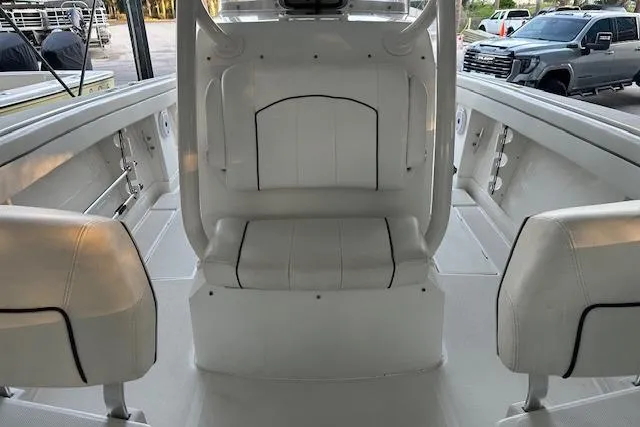 Slide: The Image of Interior view of a 2015 Jupiter 30 CC boat with white seating. - 7