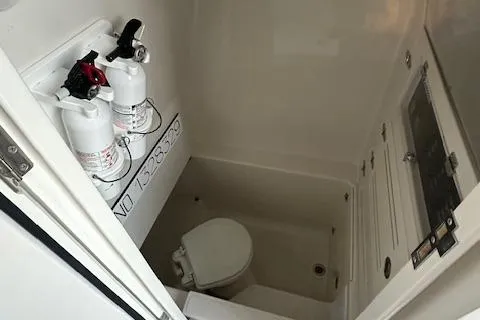 Slide: The Image of 2015 Jupiter 30 CC boat bathroom with fire extinguishers and toilet. - 8