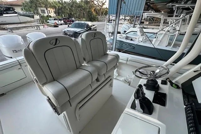 Slide: The Image of 2015 Jupiter 30 CC boat interior with dual captain's chairs and control panel. - 9