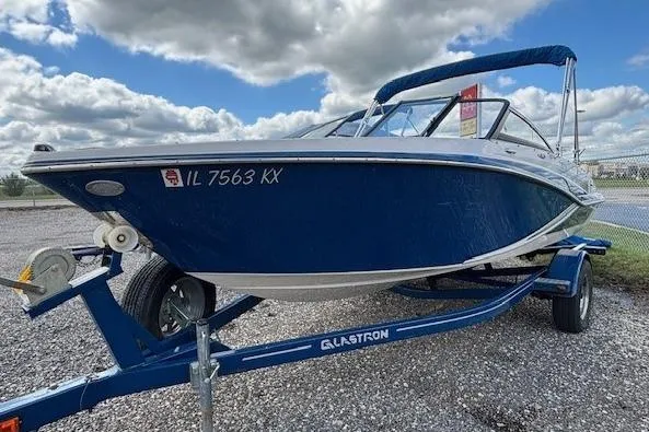 The Image of 2018 Glastron GT 187 boat on trailer under cloudy sky. - 1